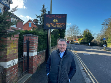 The Rt Hon Sir Robert Buckland MP next to the brand new government funded digital signs